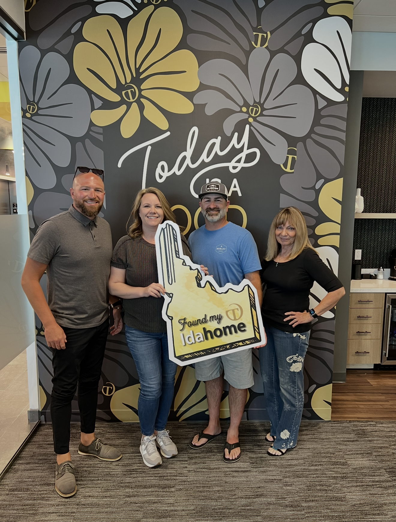 Homebuyers celebrating their move to Idaho with Carol Junge after closing on a home in the Boise Idaho area